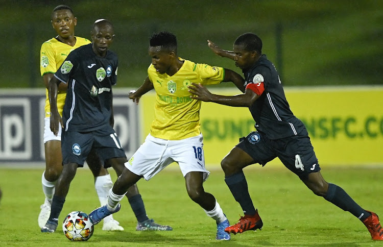 Siphamandla Motto, captain of Richards Bay FC, challenges Themba Zwane of Mamelodi Sundowns in the Nedbank Cup last-32 game at Princess Magogo Stadium in Durban on February 4 2022.