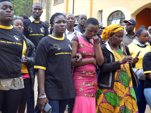 Daniel Baru's wife Rebeccah (in pink) with human rights defenders outside Migori law court on Friday, July 21, 2018. /COURTESY