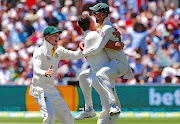 Australia's Josh Hazlewood celebrates with teammate Nathan Lyon after taking the wicket of England captain Joe Root during the fifth day of the second Ashes cricket Test at the Oval in Adelaide. Australia won by 120 runs, going 2-0 up in the series.