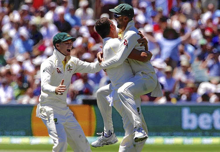 Australia's Josh Hazlewood celebrates with teammate Nathan Lyon after taking the wicket of England captain Joe Root during the fifth day of the second Ashes cricket Test at the Oval in Adelaide. Australia won by 120 runs, going 2-0 up in the series.