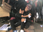 #TotalShutdown participants, Dorcas Naudé, 19, and Siphesihle Lugaju, 21, share a special moment following the march in Port Elizabeth on August 1, 2018. 