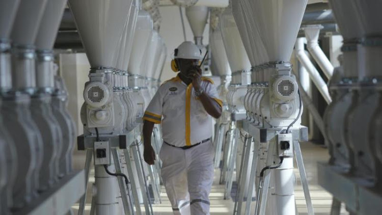 A worker inspects machines at the Grain Industries Limited