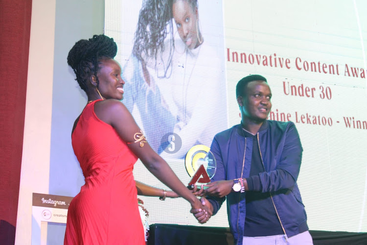 Innovative content award under 30 winner receives the award from Mike Buni during the Inaugural Content Creator Awards ceremony at the National Museums, Nairobi on April 4, 2024