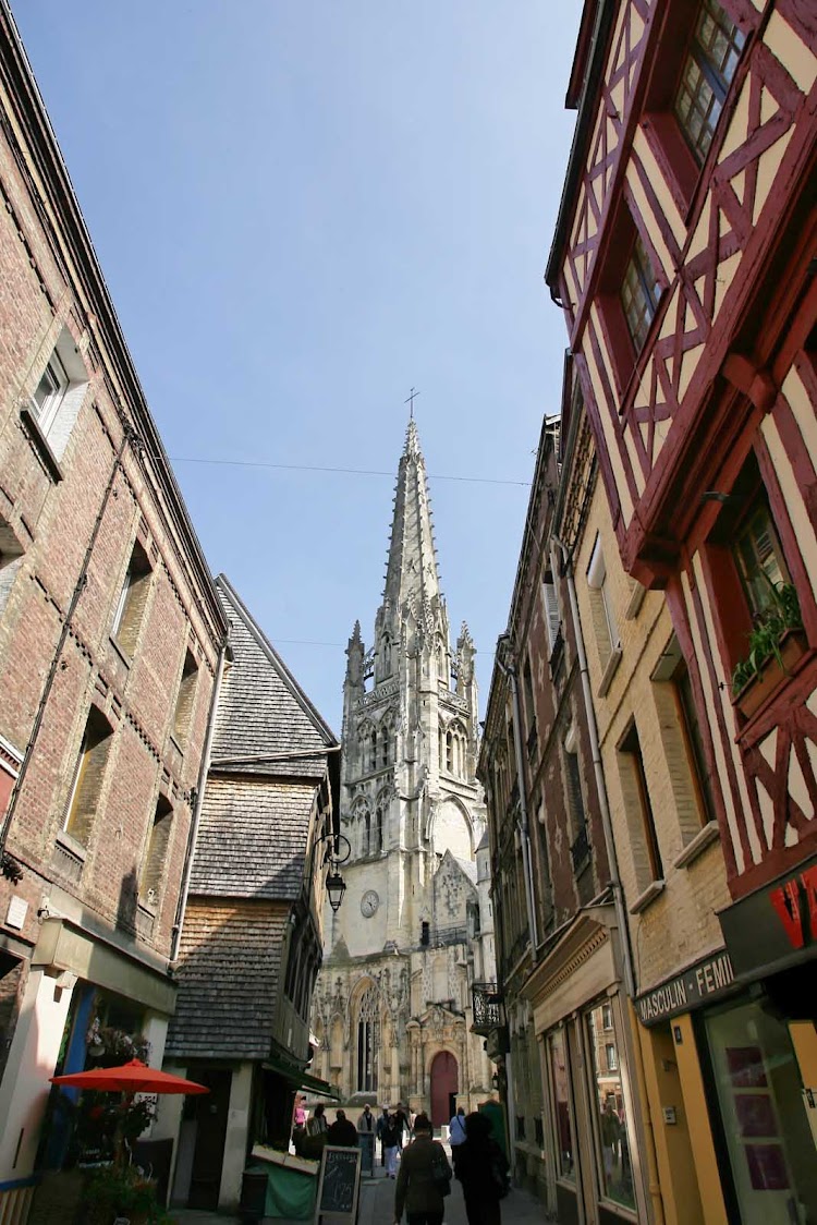 Stroll the narrow streets of Harfleur, France, with the towering cathedral as a guidepost.