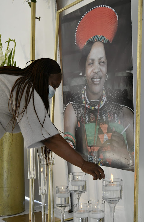 A mourner lkights a candle at National Freedom Party founder Zanele Magwaza-Msibi's funeral in Ulundi, KwaZulu-Natal, on September 11 2021.