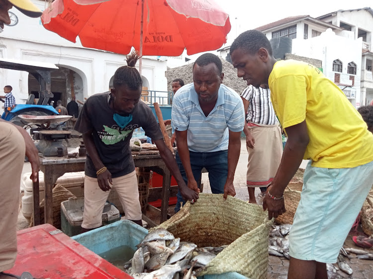 Fishermen sort out their catch in Lamu island.