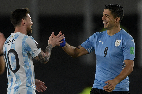 Argentina's Lionel Messi (L) greets Uruguay's Luis Suarez before the start of the South American qualification football match for the FIFA World Cup Qatar 2022, at the Monumental stadium in Buenos Aires, on October 10, 2021.