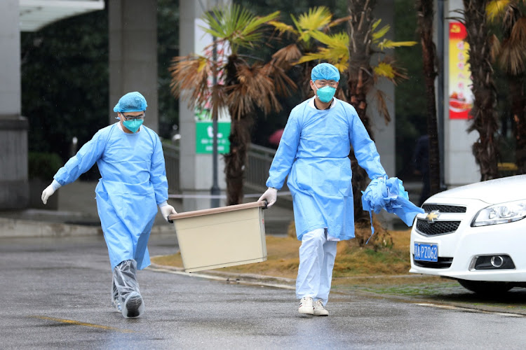 Medical staff carry a box as they walk at the Jinyintan hospital, where the patients with pneumonia caused by the new strain of coronavirus are being treated, in Wuhan, Hubei province, China, on January 10 2020. Picture: REUTERS/CHINA OUT/DARLEY SHEN