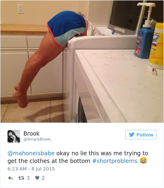 Short girl falling into the laundry machine because she is too short to lean over and grab her clothes