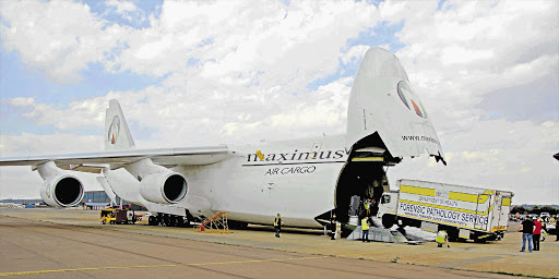 PAINFUL MISSION: Four mortuary trucks were among the vehicles loaded onto a cargo plane at Air Force Base Waterkloof in Pretoria on Friday Picture: DEPARTMENT OF COMMUNICATIONS