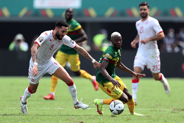 Mali's Moussa Djenepo in action with Tunisia's Dylan Bronn