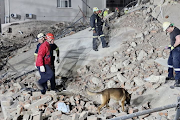 About 200 emergency services personnel are working to retrieve workers trapped under rubble at the construction site in George. 