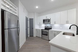 Kitchen with white cabinets and wood finish flooring