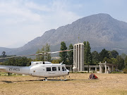 A firefighting helicopter waits alongside the Huguenot Memorial in Franschhoek on February 19 2019.