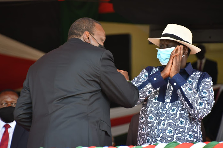 President Uhuru Kenyatta greets ODM party leader Raila Oginga during the Madaraka Day celebrations in Kisumu County.