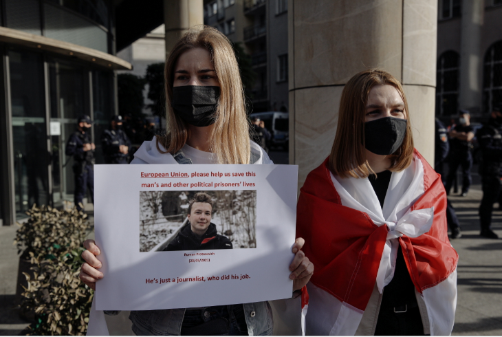 A woman displays a sign during a protest against the detention of Belarusian blogger, Roman Protasevich, who was detained as a Ryanair plane that he was on, en route from Athens to Vilnius, was forced to land in Minsk on Sunday, in Warsaw, Poland, May 24, 2021.