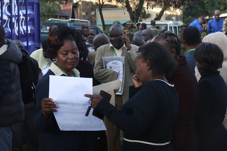 Ogande Girls High School former principal Jennifer Otollo and Homa Bay exams officer Millicent Moraa during distribution of KCSE exam papers in Homa Bay town on November 6, 2023