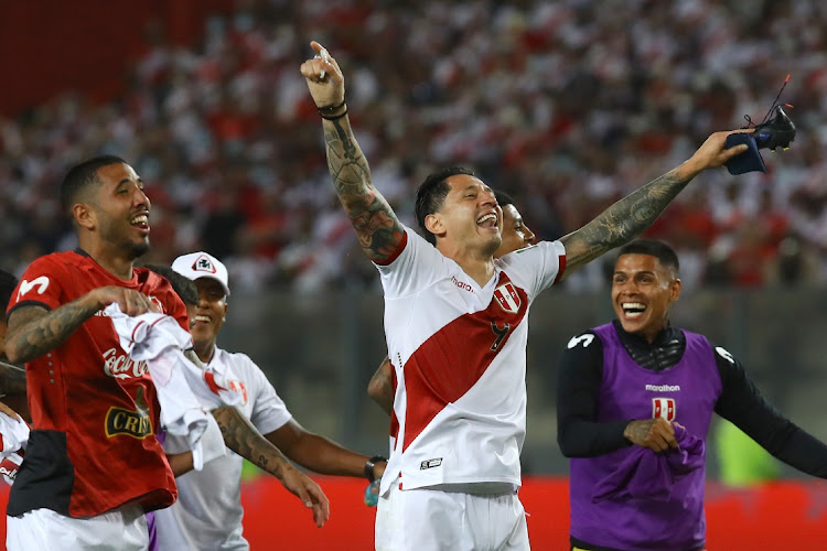 Gianluca Lapadula (centre) of Peru celebrates with teammates after winning the FIFA World Cup Qatar 2022 qualification match against Paraguay at Estadio Nacional de Lima on March 29, 2022