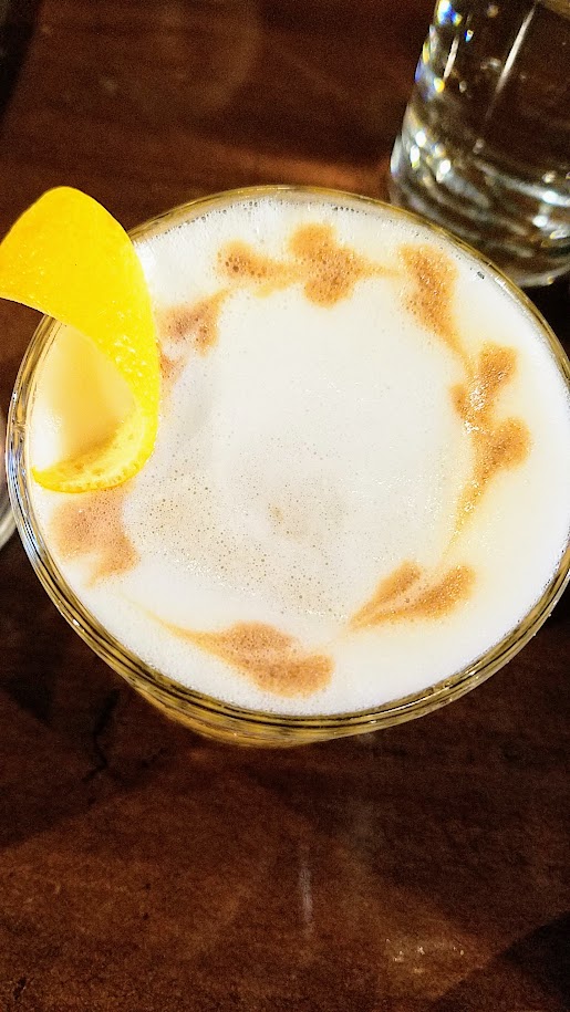 Quaintrelle, the cocktail Midnight Special, a drink with Bourbon, sherry, gran classico, lemon oil, egg white and offers full complexity, smooth, citrus forward