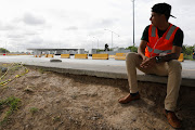 A man sits near border customs control for cargo trucks at the World Trade Bridge in Nuevo Laredo, Mexico June 5, 2019.  