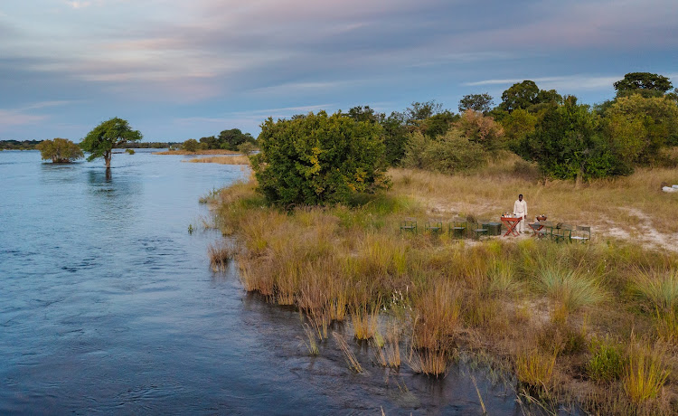 Drinks on the Zambezi at Tsowa Safari Island, Zimbabwe.