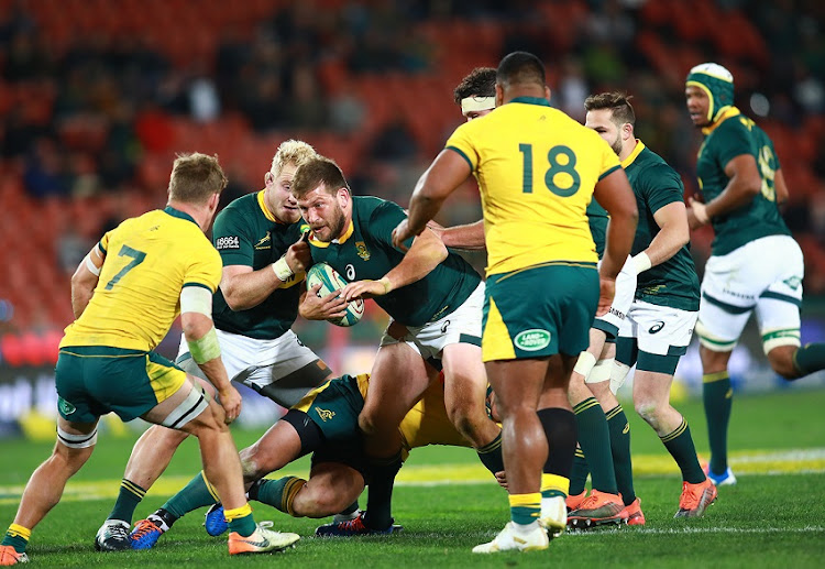 Frans Steyn of the Springboks powers through a challenge.