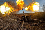 Ukrainian servicemen fire a 130 mm towed field gun M-46 on a front line, as Russia's attack on Ukraine continues, near Soledar, Donetsk region, Ukraine, in this handout image released November 10, 2022.