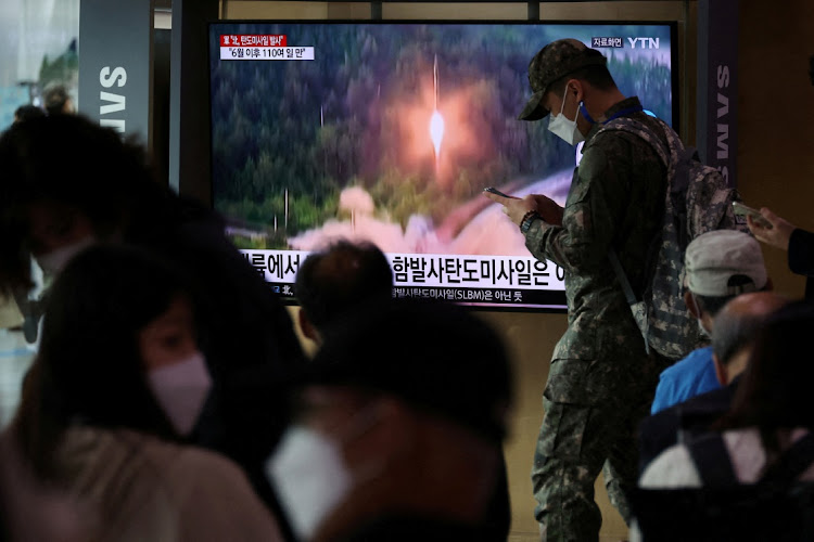 A South Korean soldiers walks past a TV broadcasting a news report on North Korea firing a ballistic missile towards the sea off its east coast, in Seoul, South Korea, September 25 2022. Picture: KIM HONG-JI/REUTERS