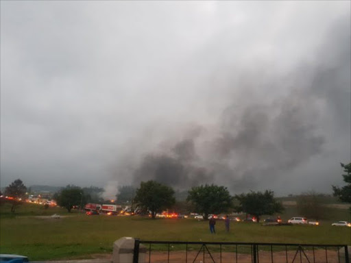 Columns of smoke rise from burning trucks on the N3 highway at the Mooi River Toll, where rioters ran rampant on Monday. Image: SUPPLIED