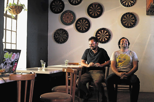 To help bring life back to the CBD Gert Schoonraad, left, and brother Stefan opened the three-week-old Great Dane bar and restaurant in Braamfontein Picture: ALON SKUY