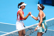 Garbine Muguruza and Clara Burel of France embrace at the net following their first round singles match during day two of the Australian Open at Melbourne Park on January 18, 2022.