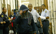 Sizzlers murder accused Trevor Theys leaves the high court in Cape Town after a court appearance in March 2004. Archive photo.
