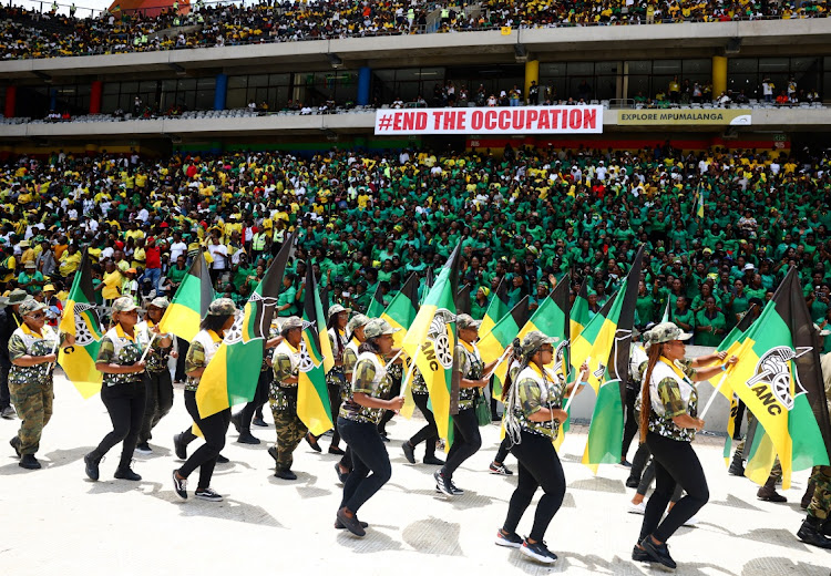 Supporters carry party flags during the ANC's 112th anniversary celebrations at Mbombela Stadium in Mpumalanga on January 13 2024. Picture: SIPHIWE SIBEKO/REUTERS