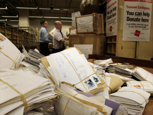 Postal workers sort through letters containing donations for the Disasters Emergency Committee Tsunami Earthquake Appeal in London. Royal Mail postal workers sort through the some of the millions of letters containing donations for the Disasters Emergency Committee Tsunami Earthquake Appeal in London January 4, 2005. /REUTERS