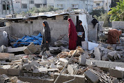 Women inspect as a house damaged in an Israeli strike lies in ruin, amid the ongoing conflict between Israel and the Palestinian Islamist group Hamas, in Rafah, in the southern Gaza Strip, May 3, 2024. 