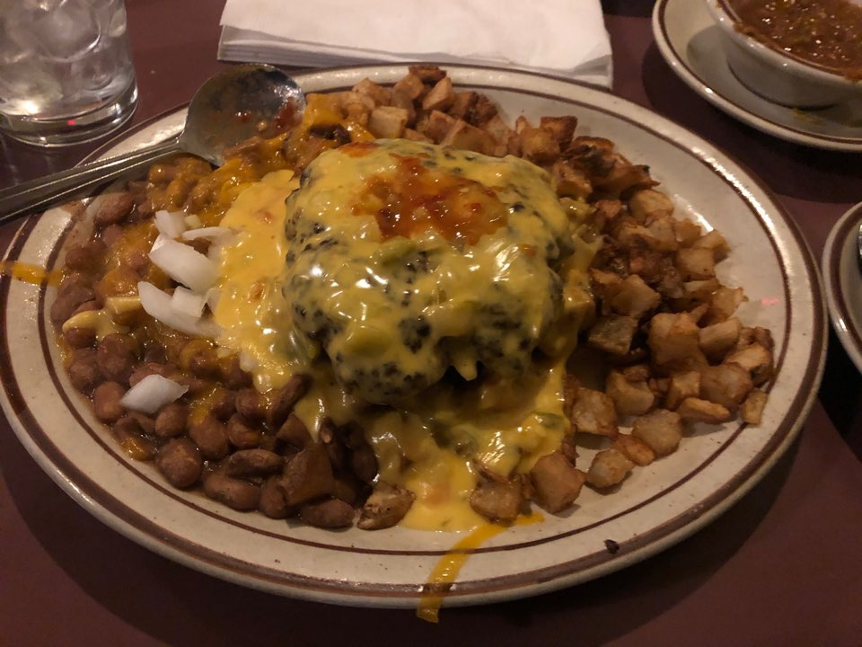 Roberto special. Potatoes fried separately from wheat. Beans gluten free. Onions and a big slab of meat with cheese with gf green Chile sauce. Looks like diner food but tastes like yummmm