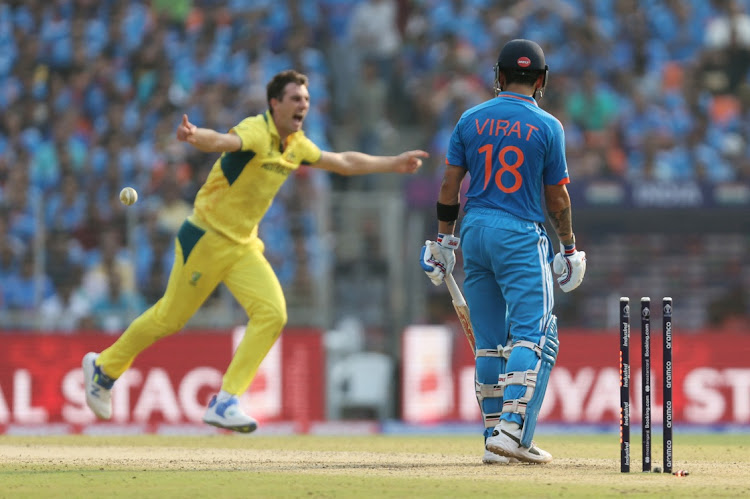 Australia's Pat Cummins celebrates after taking the wicket of India's Virat Kohli in the 2023 ICC Cricket World Cup final at Narendra Modi Stadium in Ahmedabad, India, on Sunday.