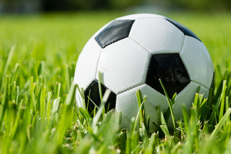 Black and white traditional soccer ball on grass