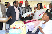 Cherol Bulose from KwaDabeka looks on as MEC Dhlomo holds her Christmas Day baby Thandolwethu, alongside (from left) Ethekwini District director Penny Msimango, acting head of department Dr Musa Gumede, head of ministry Bheki Nzimande, Sister Zoleka Ngobese and office manager Linda Zondi. Image: THEMBA MNGOMEZULU 

