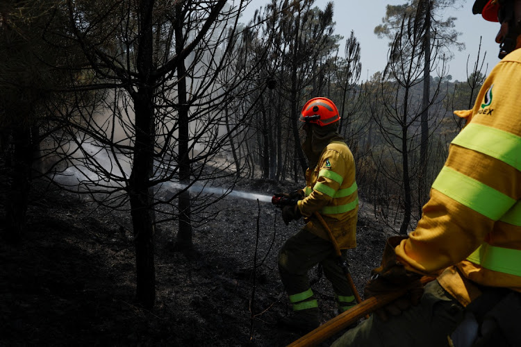 Firefighters from Extremadura work to contain a wildfire in the second heatwave of the year in the vicinity of Riomalo de Arriba, Spain, July 14 2022. Picture: REUTERS/SUSANA VERA