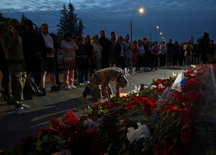 People gather at a makeshift memorial near former PMC Wagner Centre, associated with the founder of the Wagner Group, Yevgeny Prigozhin, in Saint Petersburg, Russia, on August 24 2023. Picture: REUTERS/ANASTASIA BARASHKOVA