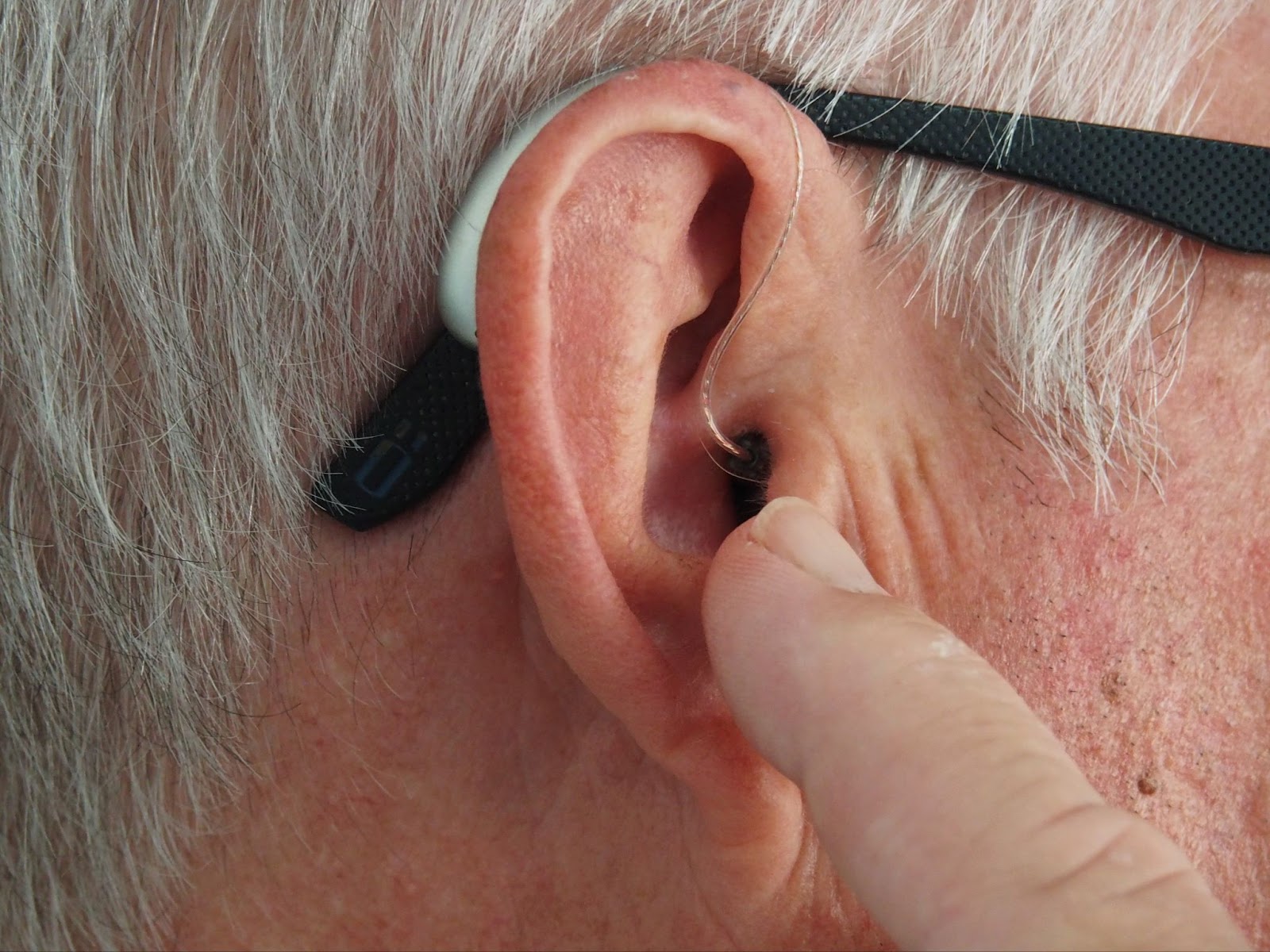 close-up of hearing aid in ear, deaf, aging, elder, senior, lose hearing