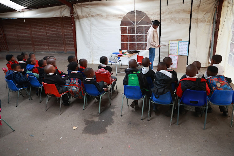 Pupils grade 1 in a tent outside at Lukholweni Primary School Orlando East, Soweto.