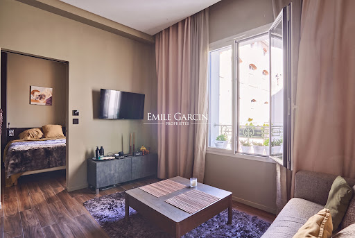 Living room with bedroom view and flowered balcony in this luxury property for sale in Paris 20ème ($297,893 - 25 m²)