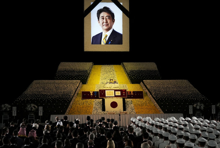 A portrait of former Japanese Prime Minister Abe Shinzo hangs on the stage during the state funeral at Nippon Budokan in Tokyo, Japan on 27 September 2022. Picture: REUTERS/FRANCK ROBICHON