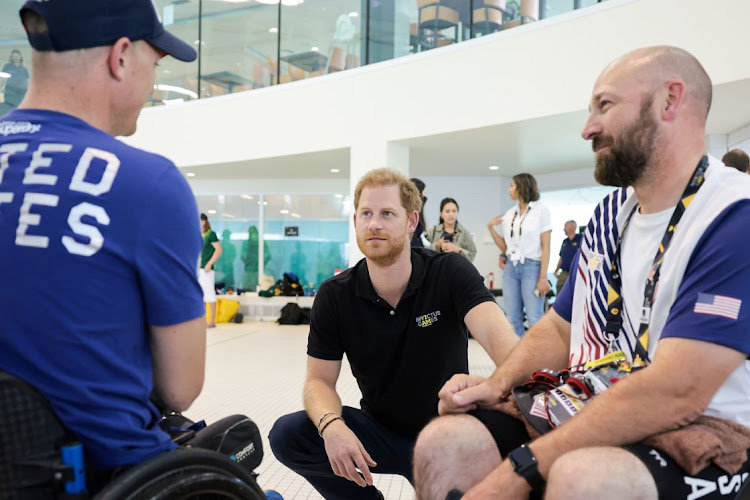 Prince Harry speaks to Invictus competitors at the swimming competition. Stock image.