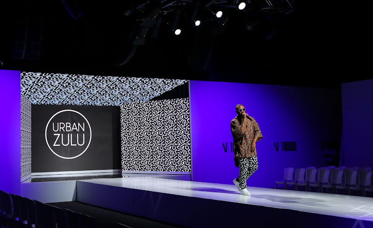 Rapper Reason performs to an audience of vacant chairs during the Urban Zulu show at AFI Fashion Week Cape Town.