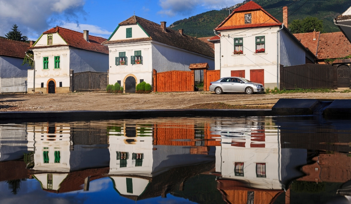 Iconic white and green houses of Rimetea, one of the most beautiful villages to know about when visiting Transylvania.