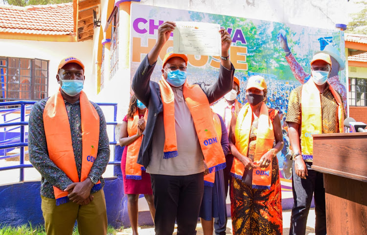 Pavel Oimeke displays his ticket at ODM headquarters on Friday