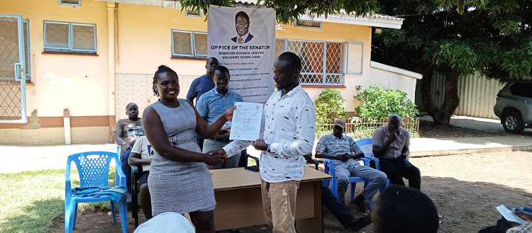 One of the youths linked to National Youth Service during the handing over of the confirmation letters at Kisumu Senator Prof Tom Ojienda's office on Wednesday. Looking on is Senator's office Manager Dr Simon Peter.